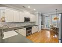 Bright kitchen featuring stainless steel appliances, white cabinets, and hardwood floors at 167 Palm Cove Way Way, Mount Pleasant, SC 29466