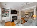 Cozy living room with fireplace, built-in bookshelves, and seamless flow to the dining area at 167 Palm Cove Way Way, Mount Pleasant, SC 29466