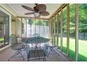 Inviting screened patio featuring a ceiling fan and outdoor dining set at 169 Historic Dr, Mount Pleasant, SC 29464