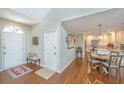 Inviting foyer features hardwood floors, a bench, and opens to the dining area and kitchen at 181 Sea Cotton Cir, Charleston, SC 29412