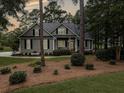 Charming one-story home features neutral siding, black shutters, and manicured landscaping at 195 Prestwick Ct, Summerville, SC 29483