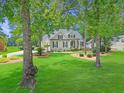 Inviting one-story home with a lush green lawn and mature trees in a serene neighborhood at 195 Prestwick Ct, Summerville, SC 29483
