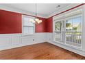 Bright dining room with hardwood floors, white trim, and large windows at 213 Crossandra Ave, Summerville, SC 29483