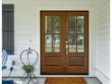 Elegant wood double front doors with glass panels and stylish hardware, enhancing curb appeal at 217 7Th Ave, Mount Pleasant, SC 29464