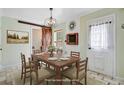 Rustic dining room with a wooden table, chandelier, barn door, and a digitally altered appearance at 236 Emerald Isle Dr, Moncks Corner, SC 29461