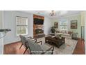 Cozy living room features a fireplace, stone accent wall, and comfortable seating with digitally altered elements at 236 Emerald Isle Dr, Moncks Corner, SC 29461