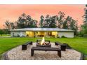 Spacious backyard with fire pit, bench seating, and expansive lawn at 242 Cheyenne Rd, Summerville, SC 29483