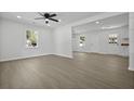 Bright, airy living room with new flooring, fresh white paint, and modern ceiling fan at 267 Industrial Rd, Walterboro, SC 29488