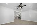 Open-concept living space featuring sleek flooring, recessed lighting, and view to kitchen with stainless appliances at 267 Industrial Rd, Walterboro, SC 29488