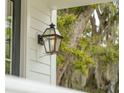 Classic gas lantern on the front porch of a home with white siding and inviting ambiance at 2815 Colonel Harrison Drive Dr, Johns Island, SC 29455