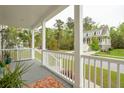 Inviting covered front porch with railing, offering a glimpse of the neighborhood at 2815 Colonel Harrison Drive Dr, Johns Island, SC 29455