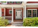 The front door is framed by white columns and decorative shrubbery at 2941 Murraywood Rd, Johns Island, SC 29455