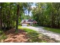 Charming two-story red home surrounded by lush trees at 2941 Murraywood Rd, Johns Island, SC 29455