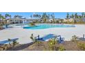 Community pool area surrounded by lounge chairs, landscaping, and trees at 306 Lucca Dr, Summerville, SC 29486