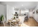 Sunlit kitchen with light wood floors, white cabinets, granite countertops and stainless steel appliances at 326 Tiliwa St, Summerville, SC 29486
