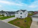 Inviting two-story home with a well-maintained lawn and blue shutters, nestled in a peaceful neighborhood setting at 330 Bountiful Dr, Moncks Corner, SC 29461