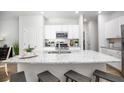 Modern kitchen with granite counters, white cabinets, stainless appliances, and an island with bar seating at 345 Pine Crest View Dr, Summerville, SC 29486