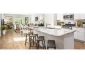 Stylish kitchen with a granite countertop island, seating, stainless appliances, and views to the living area at 345 Pine Crest View Dr, Summerville, SC 29486