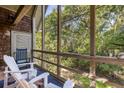 Inviting screened-in porch with Adirondack chairs, providing a cozy and scenic outdoor living space at 3577 Shipwatch Rd, Kiawah Island, SC 29455