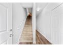 Inviting entryway displaying staircase, modern door and light wood-look flooring at 4551 Great Oak Dr, North Charleston, SC 29418