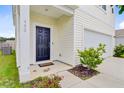 Inviting front porch with a dark-colored front door and decorative plants and an ADT security system at 490 Pender Woods Dr, Summerville, SC 29486