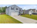 Well-manicured lawn and long driveway leading to a beautiful two-story home at 493 Spanish Wells Rd, Summerville, SC 29486