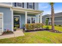 Inviting front porch with beautiful landscaping and a welcoming front door at 493 Spanish Wells Rd, Summerville, SC 29486