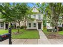 Charming home with neat front yard, complemented by lush trees and landscaping at 4938 Ballantine Dr, Summerville, SC 29485
