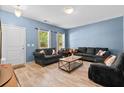 Bright living room featuring hardwood floors, comfortable seating, and an abundance of natural light at 4938 Ballantine Dr, Summerville, SC 29485