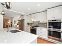 Modern kitchen with white cabinets, stainless steel appliances, and island with quartz countertops at 51 Stocker Dr, Charleston, SC 29407