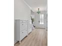 Bright entryway features stylish shoe cabinet, wood floors and decorative light fixture with beautiful stained-glass accents at 5133 Park Creek Ave, North Charleston, SC 29418