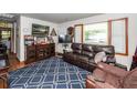 Cozy living room with a large window, comfortable seating, and a patterned blue rug at 5209 Sterrett St, North Charleston, SC 29405