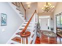 Elegant foyer with wood floors, staircase, stylish chandelier, and ample natural light, creating a welcoming entrance at 544 Two Mile Run, Johns Island, SC 29455