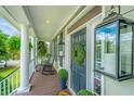 Inviting front porch with comfortable seating, stylish decor, and classic lanterns, offering a relaxing outdoor space at 544 Two Mile Run, Johns Island, SC 29455