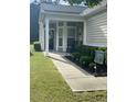 Inviting covered porch with rocking chairs and a beautifully landscaped front yard at 556 Sea Foam St, Summerville, SC 29486