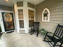 Cozy covered porch featuring rocking chairs, decorative wreaths, and charming accents at 556 Sea Foam St, Summerville, SC 29486