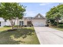 Charming single-story home with a well-maintained lawn and a two car garage at 602 Eastern Isle Ave, Summerville, SC 29486