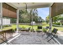 Screened-in porch with comfortable seating and a serene view of the backyard pond at 602 Eastern Isle Ave, Summerville, SC 29486