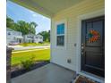 Welcoming front porch featuring stylish decor, a charming wreath, and a glimpse of the lovely neighborhood at 602 Jancus St, Charleston, SC 29414