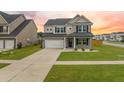 Charming two-story home with a two car garage, well-manicured lawn, and craftsman-style details at 701 Squire Pope Rd, Summerville, SC 29486