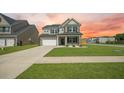 Charming two-story home with a two car garage, well-manicured lawn, and craftsman-style details at 701 Squire Pope Rd, Summerville, SC 29486