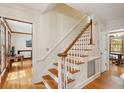 Bright foyer showcasing a hardwood staircase with white risers and beautiful wood floors at 712 Wakendaw Blvd, Mount Pleasant, SC 29464