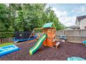 Spacious backyard with a playset, slide, swing, and trampoline offering outdoor fun at 9836 Black Tupelo Ln, Ladson, SC 29456