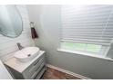 Modern powder room with a vessel sink, brushed nickel faucet, and shiplap accent wall near a window at 9836 Black Tupelo Ln, Ladson, SC 29456