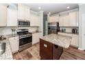 Bright kitchen featuring stainless steel appliances, granite countertops, and a stylish island with wood flooring at 9836 Black Tupelo Ln, Ladson, SC 29456