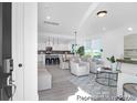 Bright, open-concept living area with modern furnishings, light gray wood floors, and an eat-in kitchen at 1023 Marsh Harrier Dr # Cc3-3-5P, Ravenel, SC 29470