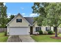 Charming home with a well-maintained lawn, two-car garage, and traditional architecture at 104 Lancaster Ct, Goose Creek, SC 29445