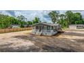 New single-story home featuring a covered porch and neutral siding in a community undergoing landscape installation at 108 Wisteria Falls Ln, Saint Stephen, SC 29479