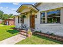 Welcoming front porch with decorative accents, brick steps, and a charming, cozy curb appeal at 111 Circle Dr, Summerville, SC 29485