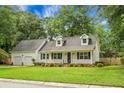 Charming one-story home featuring a well-manicured lawn, two-car garage, and a welcoming front porch at 114 Heritage St, Summerville, SC 29485